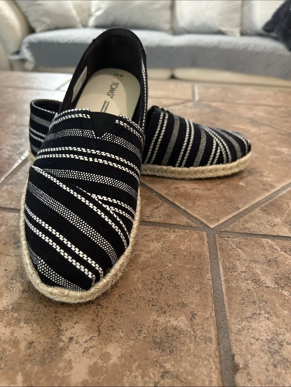 TOMS. Black striped espadrilles, size 8 and a half.  Excellent condition.